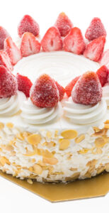 Vanilla ice cream cake with strawberry on top isolated on white background